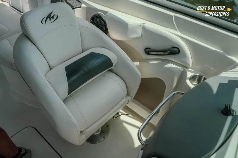 Slide: The Image of 2012 Monterey 264FS boat interior with white captain's chair and dashboard details. - 37