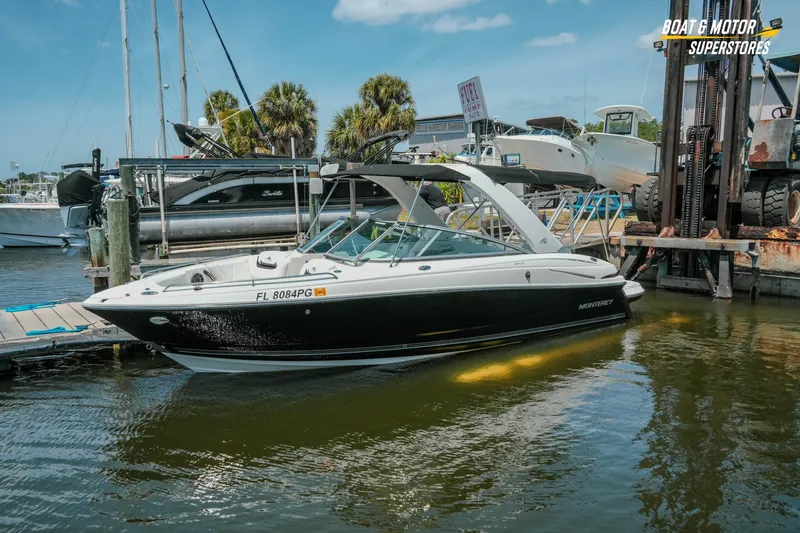 Slide: The Image of 2012 Monterey 264FS boat docked at marina, sunny day, palm trees in background. - 5