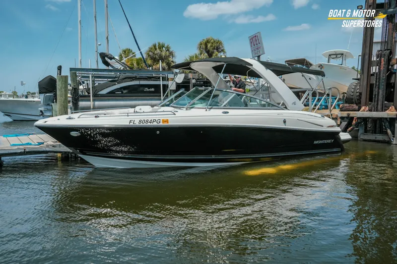 Slide: The Image of 2012 Monterey 264FS boat docked at marina under clear blue sky. - 6