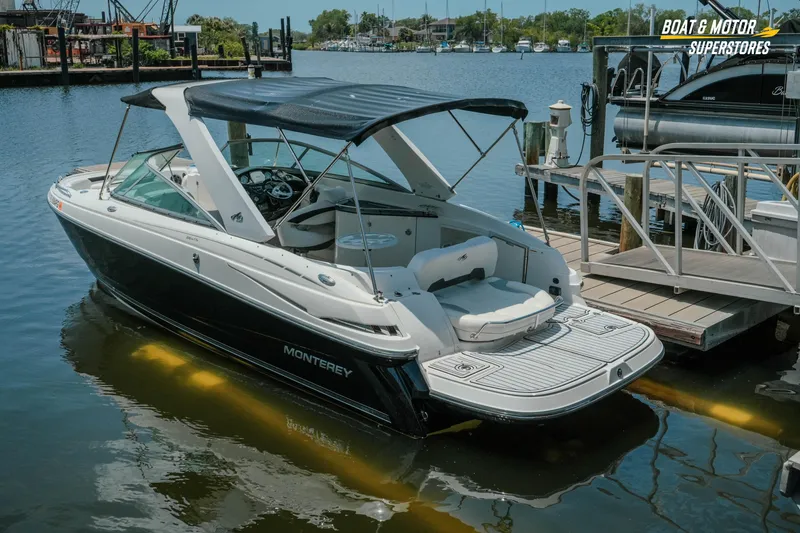 Slide: The Image of 2012 Monterey 264FS boat docked at marina, featuring sleek design and spacious seating. - 8