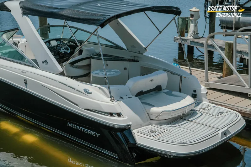Slide: The Image of 2012 Monterey 264FS boat docked, featuring sleek design and spacious seating area. - 9