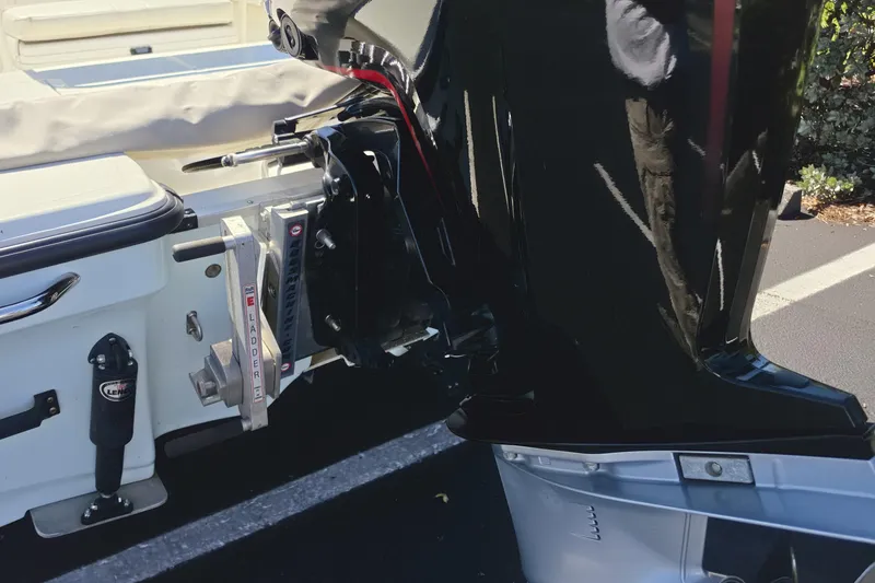 Slide: The Image of 2023 Mako 18 LTS boat with a mounted outboard motor and ladder. - 12