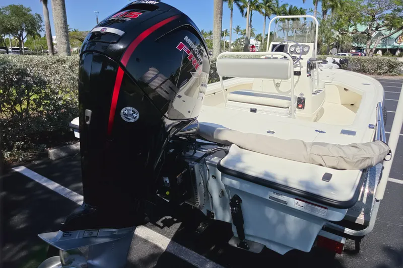 Slide: The Image of 2023 Mako 18 LTS boat with Mercury outboard motor in a parking lot. - 13