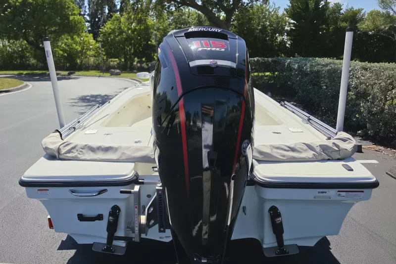 Slide: The Image of 2023 Mako 18 LTS boat with Mercury 115 Pro XS engine, parked outdoors. - 14