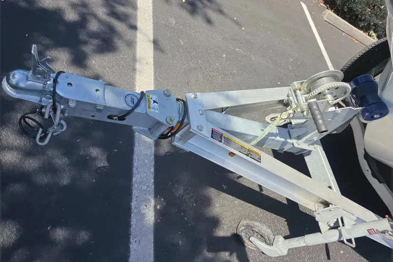 Slide: The Image of Trailer hitch and winch system for 2023 Mako 18 LTS boat in parking lot. - 16