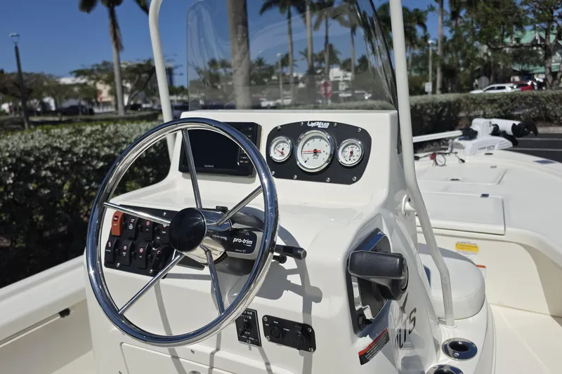 Slide: The Image of 2023 Mako 18 LTS boat dashboard with steering wheel and gauges. - 6