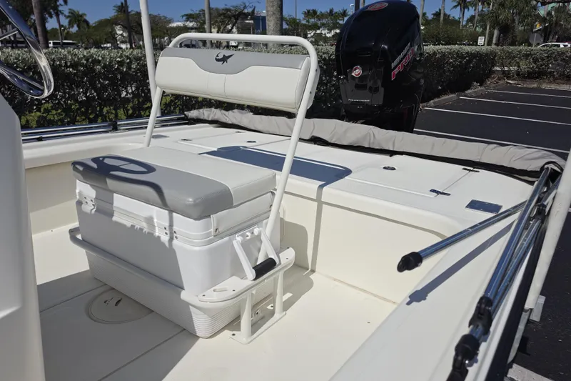 Slide: The Image of 2023 Mako 18 LTS boat interior with seating and storage, featuring a Mercury engine. - 9