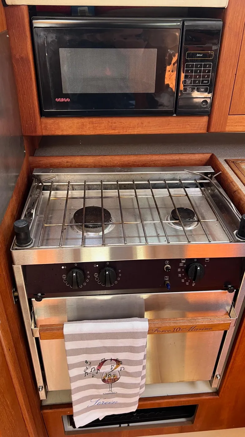 Slide: The Image of Kitchen area in a 2001 Hunter 340 yacht with stove and microwave. - 15
