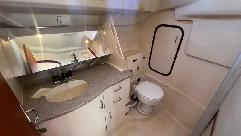 Slide: The Image of Interior of a 2001 Hunter 340 yacht, featuring bathroom with sink and toilet. - 22