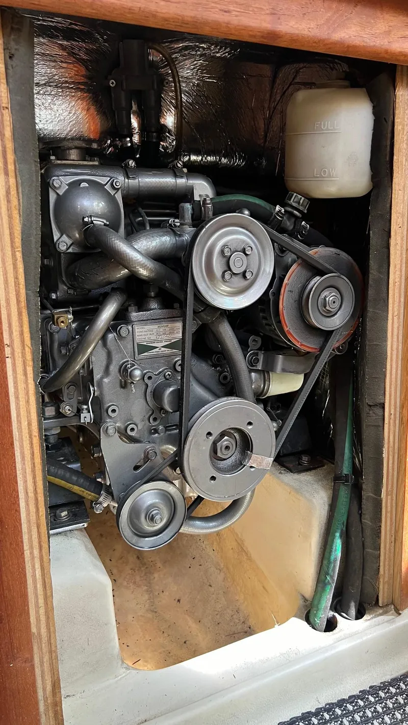 Slide: The Image of Engine compartment of a 2001 Hunter 340 with visible belts and hoses. - 26