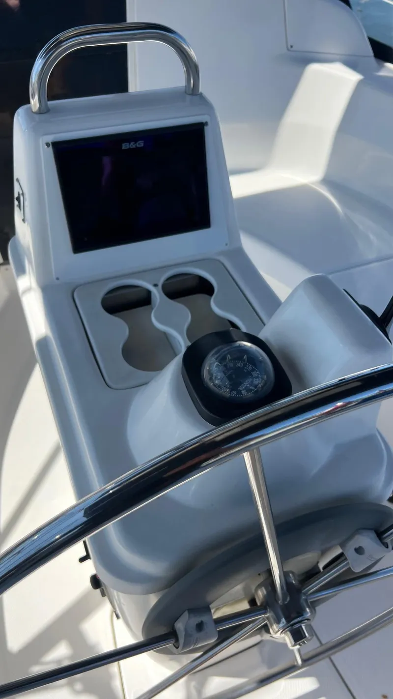 Slide: The Image of Cockpit of a 2001 Hunter 340 yacht with compass and cup holders. - 44