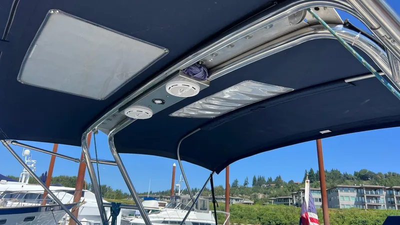 Slide: The Image of Bimini top of a 2001 Hunter 340 sailboat in a marina. - 49