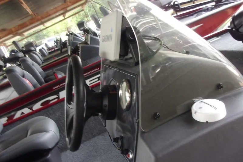 Slide: The Image of 2024 Tracker Bass Tracker Classic XL boat interior with steering wheel and Garmin device. - 10