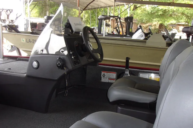 Slide: The Image of 2024 Tracker Bass Tracker Classic XL boat interior with steering console and seating. - 11