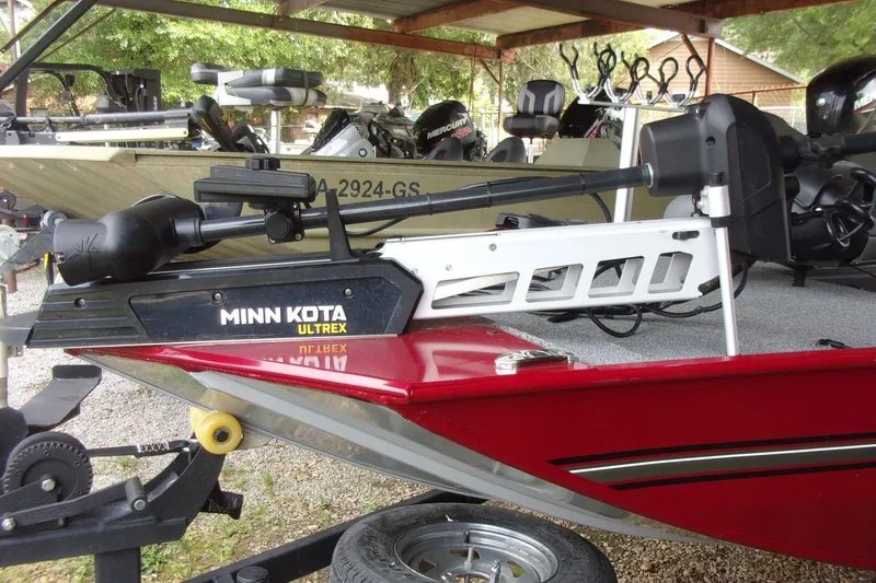 Slide: The Image of 2024 Tracker Bass Tracker Classic XL with Minn Kota Ultrex motor in a covered area. - 2