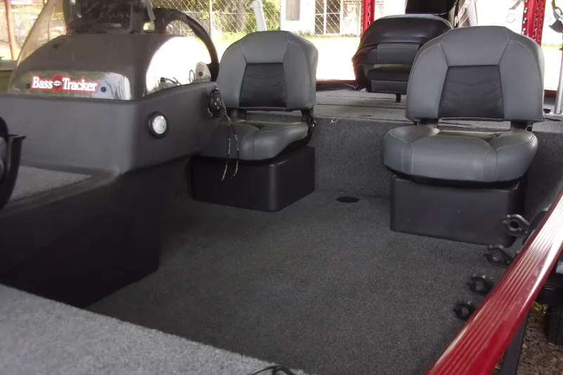 Slide: The Image of 2024 Tracker Bass Tracker Classic XL interior with dual gray seats and steering console. - 3