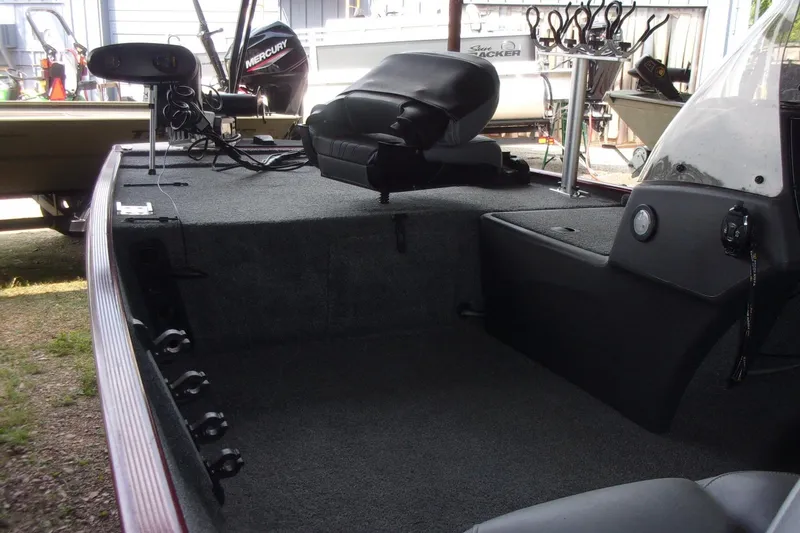 Slide: The Image of 2024 Tracker Bass Tracker Classic XL boat interior with seating and fishing equipment. - 4