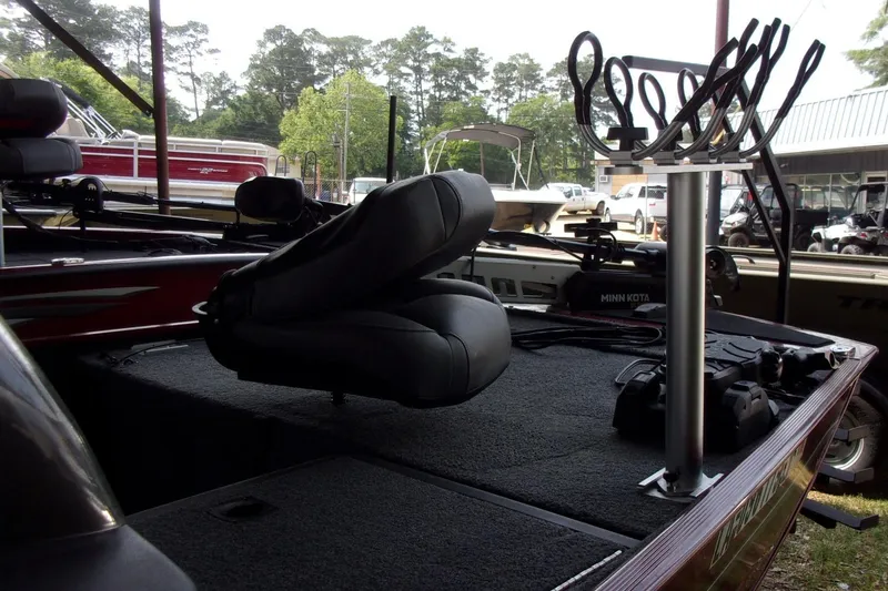 Slide: The Image of 2024 Tracker Bass Tracker Classic XL boat interior with seating and fishing rod holders. - 5