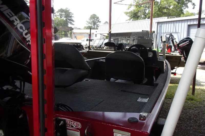 Slide: The Image of 2024 Tracker Bass Tracker Classic XL boat interior with seating and Mercury engine. - 7