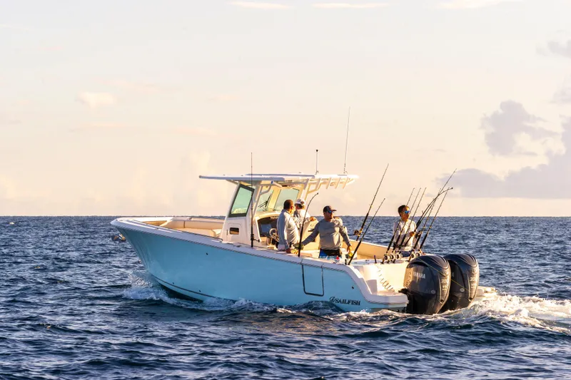 The Image of 2026 Sailfish 312 CC boat with anglers fishing at sea during sunset. - 1