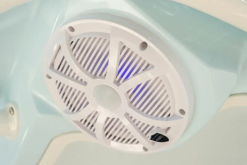 Slide: The Image of Close-up of a speaker on a 2026 Sailfish 312 CC boat, featuring blue LED lighting. - 10