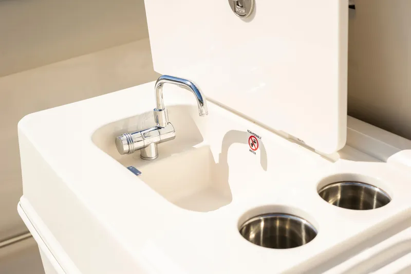 Slide: The Image of Sailfish 312 CC 2026 boat sink with faucet and cup holders. - 13