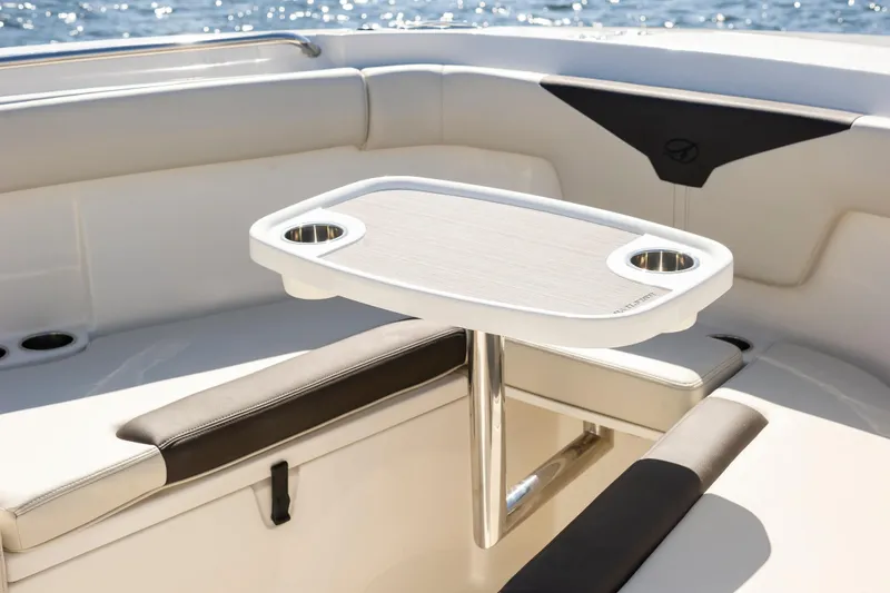 Slide: The Image of 2026 Sailfish 312 CC boat interior with table and seating, ocean in background. - 15