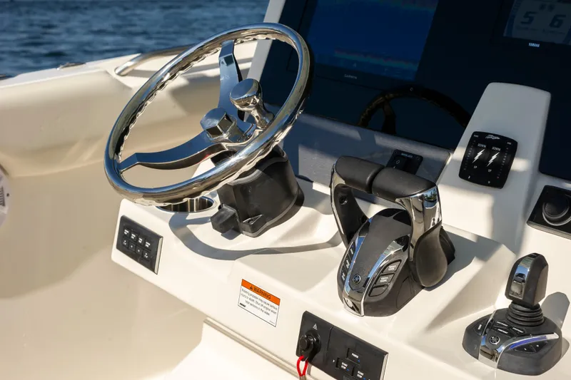 Slide: The Image of 2026 Sailfish 312 CC boat helm with steering wheel and controls. - 20
