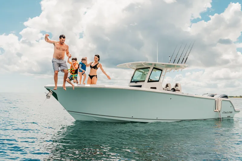 Slide: The Image of Family enjoying a day on the water with a 2026 Sailfish 312 CC boat. - 25