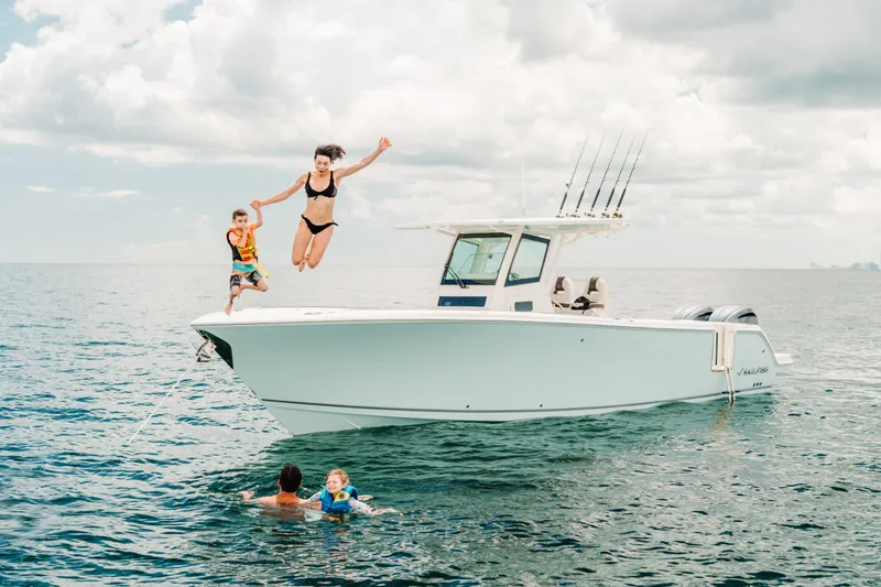 Slide: The Image of Family enjoying a day on the water with a 2026 Sailfish 312 CC boat. - 26
