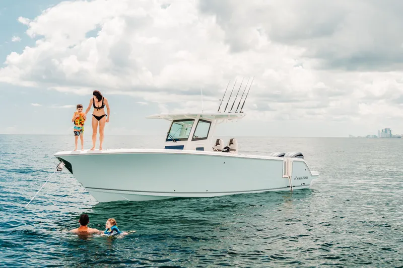 Slide: The Image of Family enjoying a day on the water with a 2026 Sailfish 312 CC boat. - 29
