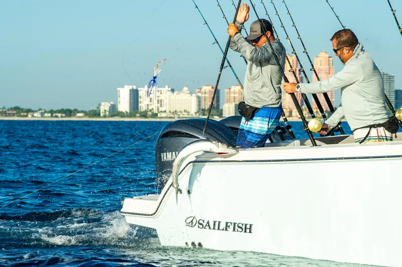 Slide: The Image of Two men fishing on a 2026 Sailfish 312 CC boat near a city skyline. - 5