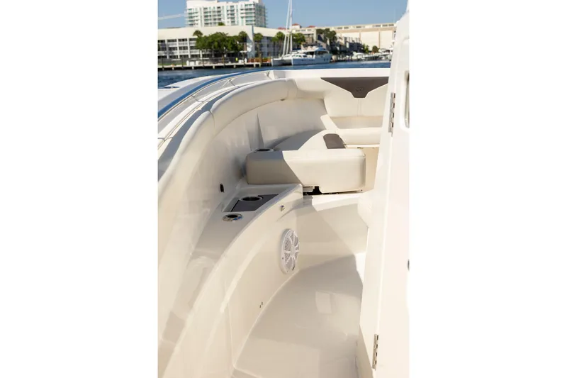 Slide: The Image of 2026 Sailfish 312 CC boat interior with seating and cup holders, dockside view. - 8