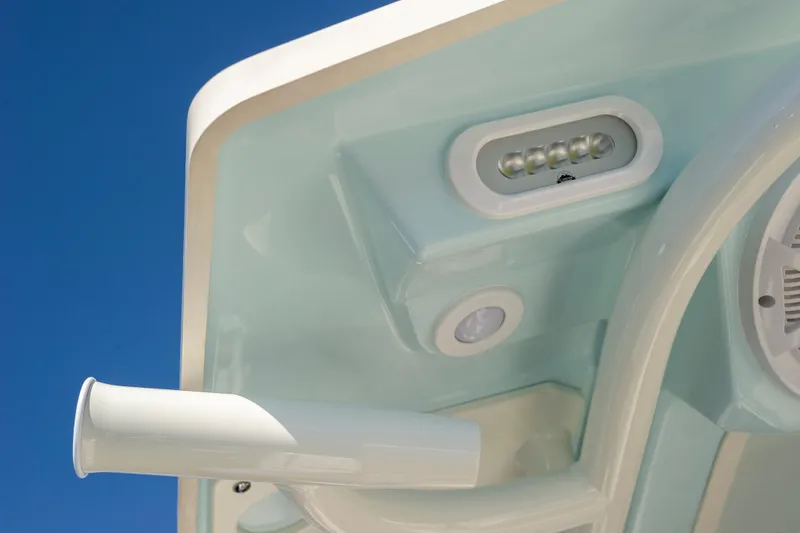 Slide: The Image of Close-up of 2026 Sailfish 312 CC boat's LED lighting and rod holder against blue sky. - 9