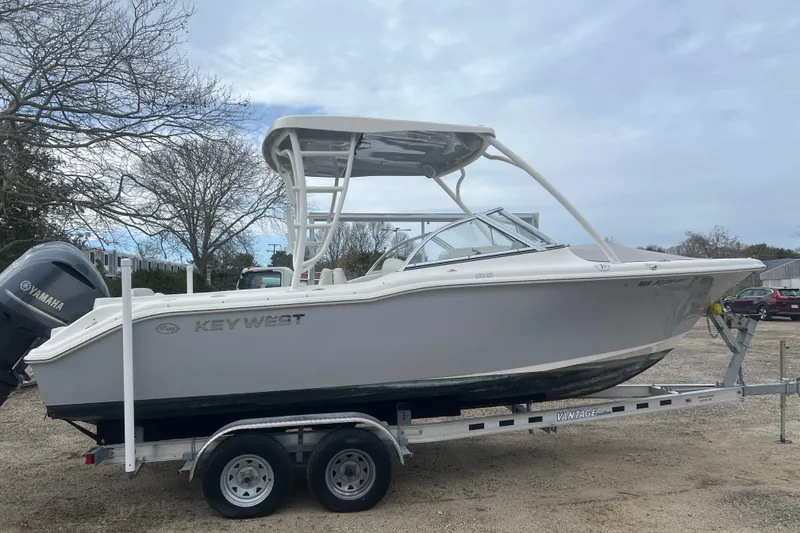 The Image of 2022 Key West 239 DFS boat on trailer, parked outdoors with Yamaha engine. - 1
