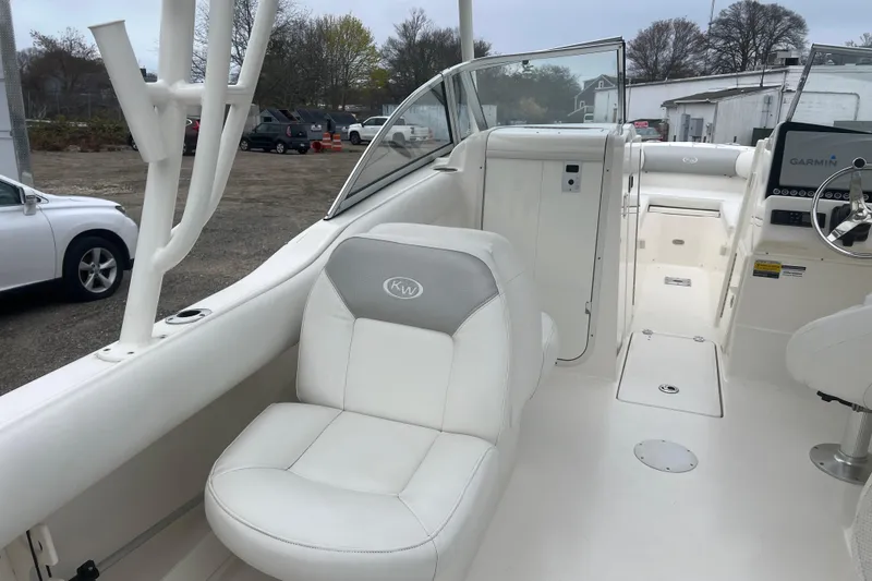 Slide: The Image of 2022 Key West 239 DFS boat interior with white seating and Garmin navigation system. - 10