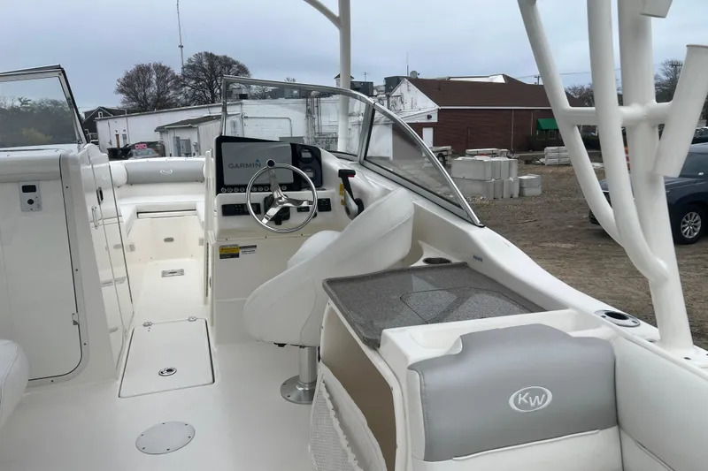 Slide: The Image of 2022 Key West 239 DFS boat interior with steering wheel and Garmin display. - 11