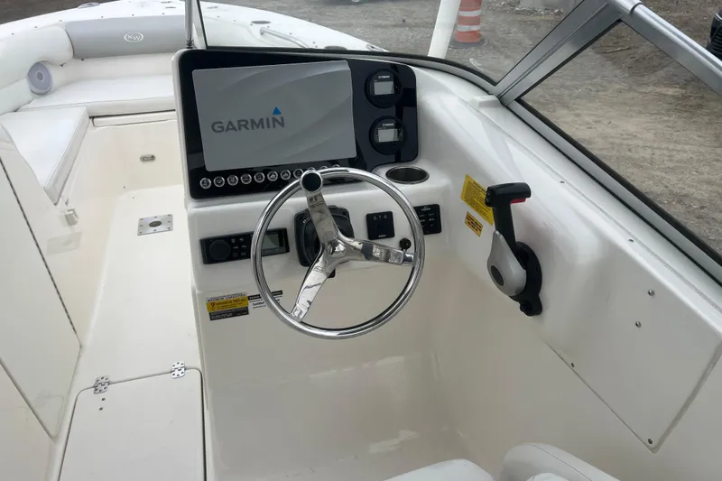 Slide: The Image of 2022 Key West 239 DFS boat dashboard with Garmin navigation system and steering wheel. - 12