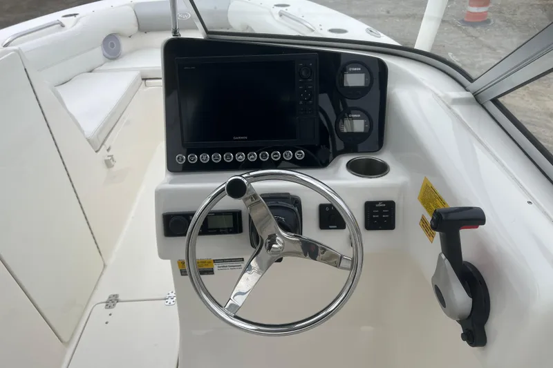 Slide: The Image of Steering console of 2022 Key West 239 DFS boat with Garmin display and controls. - 13