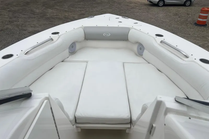 Slide: The Image of 2022 Key West 239 DFS boat interior with white cushioned seating and cup holders. - 18