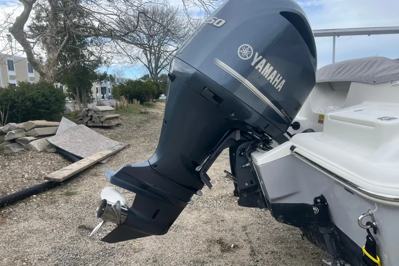 Slide: The Image of 2022 Key West 239 DFS boat with Yamaha outboard motor in a yard setting. - 27