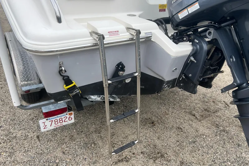 Slide: The Image of 2022 Key West 239 DFS boat with ladder and outboard motor, Massachusetts trailer plate visible. - 30