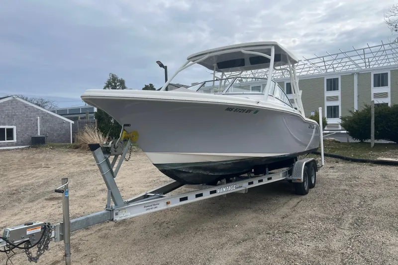 Slide: The Image of 2022 Key West 239 DFS boat on trailer, parked outdoors near buildings. - 4