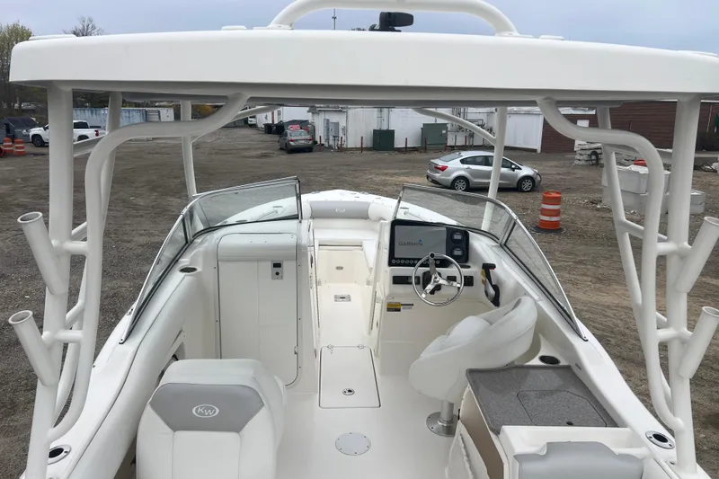 Slide: The Image of 2022 Key West 239 DFS boat interior with steering wheel and Garmin display. - 7