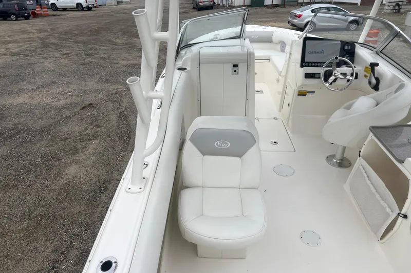 Slide: The Image of 2022 Key West 239 DFS boat interior with white seating and Garmin navigation system. - 8