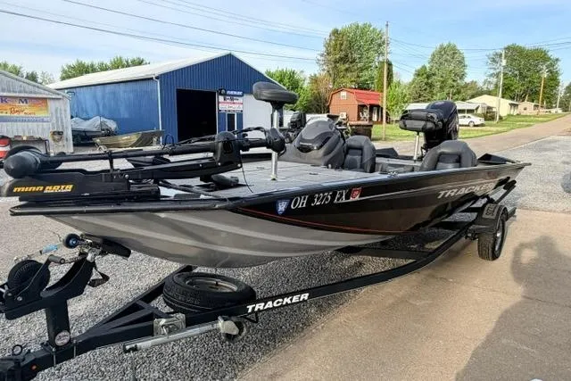 Slide: The Image of 2019 Bass Tracker Pro 19 fishing boat on trailer, parked outdoors. - 11