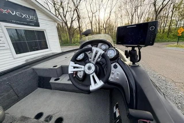 Slide: The Image of 2019 Bass Tracker Pro 19 boat interior with steering wheel and navigation system. - 5