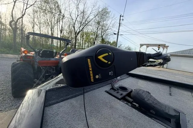 Slide: The Image of 2019 Bass Tracker Pro 19 boat with trolling motor, parked near a tractor. - 9