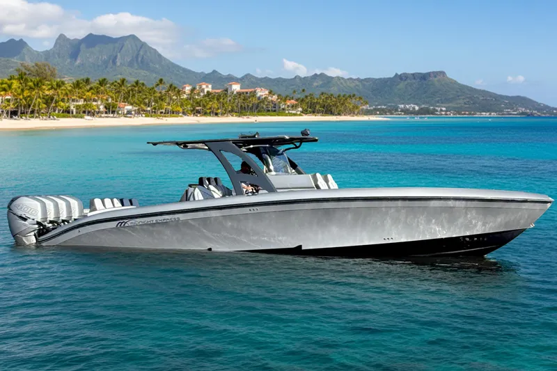 The Image of 2021 Midnight Express 37 Open boat cruising in tropical waters near a scenic coastline. - 0