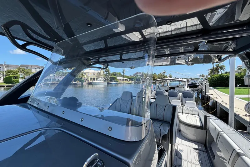 Slide: The Image of 2021 Midnight Express 37 Open boat interior with luxurious seating and waterfront view. - 6